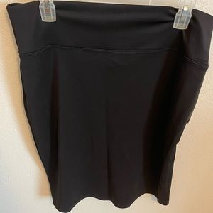 Black stretch pencil skirt with rear slit. Above knee size 1X.